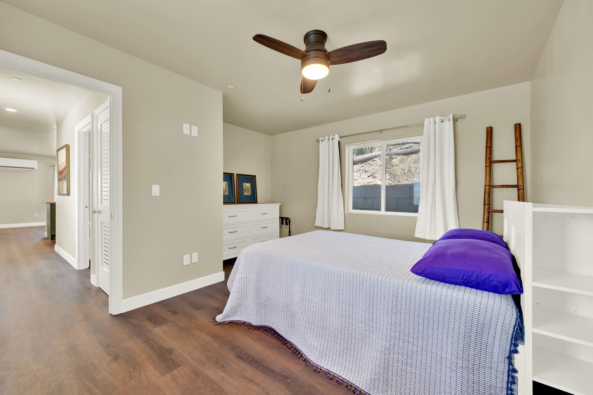 The bedroom, looking back toward the living room. A full-size room, not a nook carved out of the plan.