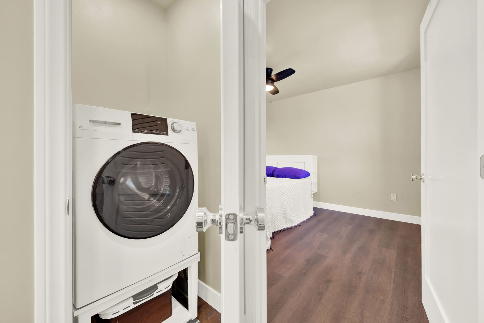 Laundry sits in its own closet right off the bedroom, with the plumbing and venting run to reach it.