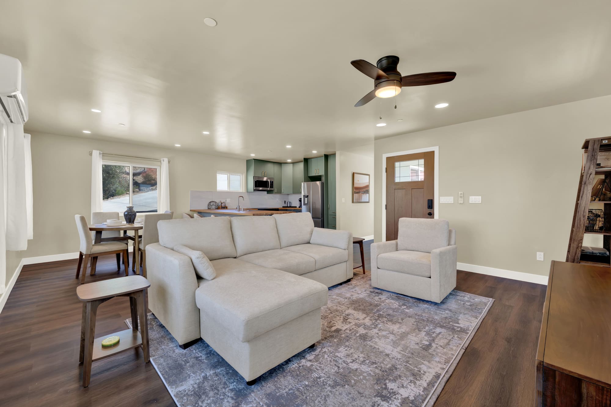 The living room sits directly off the kitchen, with its own front door opening into it.