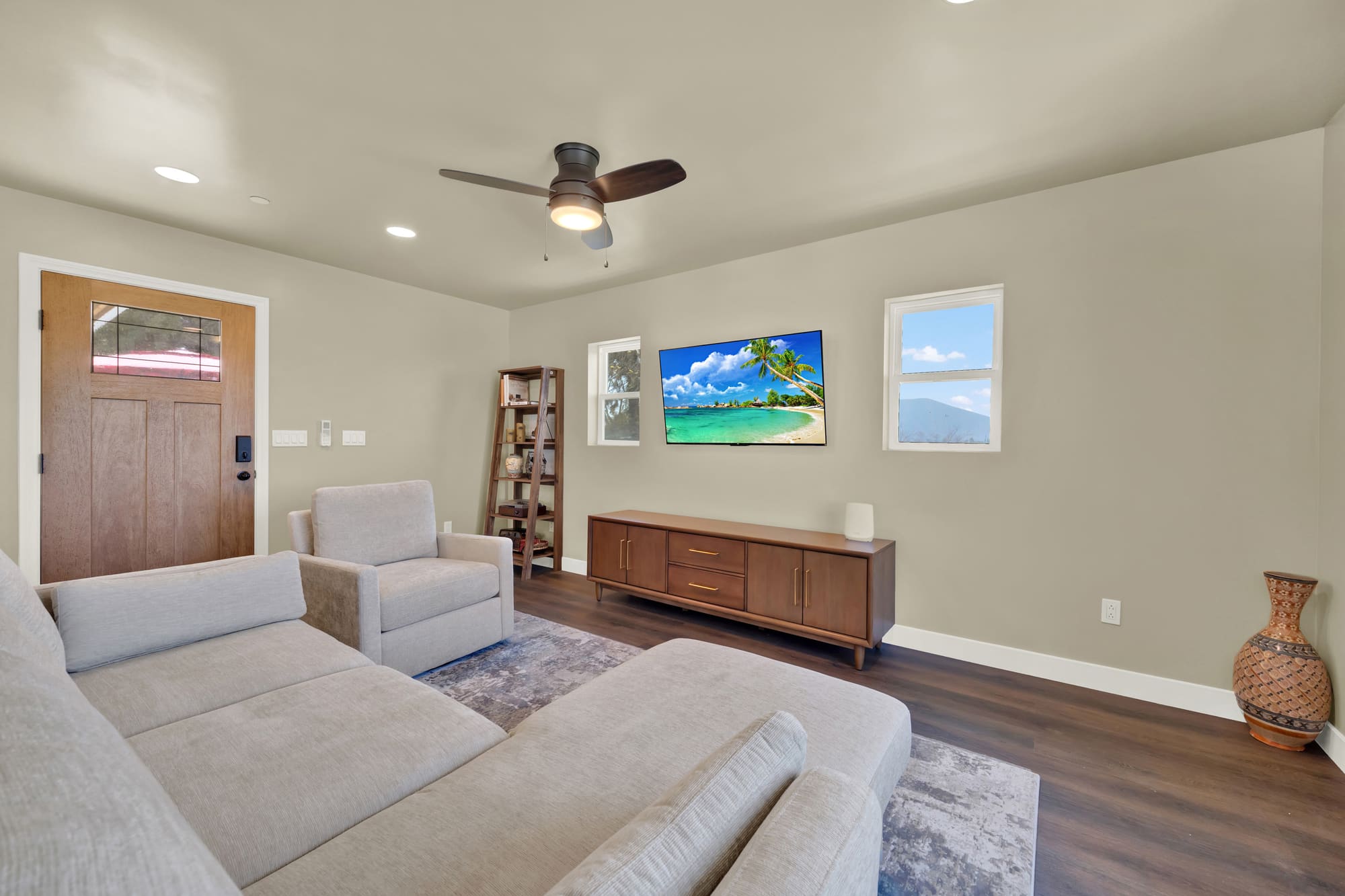 Wide-plank flooring and a private entrance. The stained door has a divided-lite window and a smart lock.